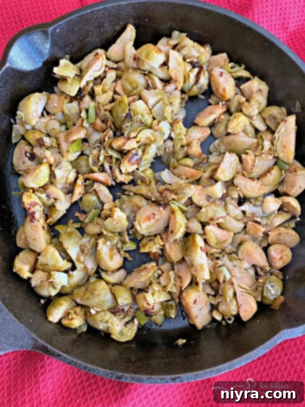 Sautéing garlic, green onion, and Brussels sprouts in leftover bacon grease for the dip