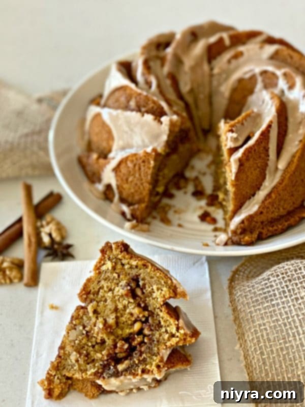 A delectable slice of Cinnamon Spice Coffee Cake showing the rich walnut spice tunnel