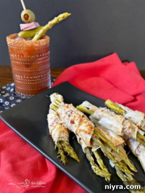Bacon & Cheese Phyllo Wrapped Pickled Asparagus served with a Bloody Mary