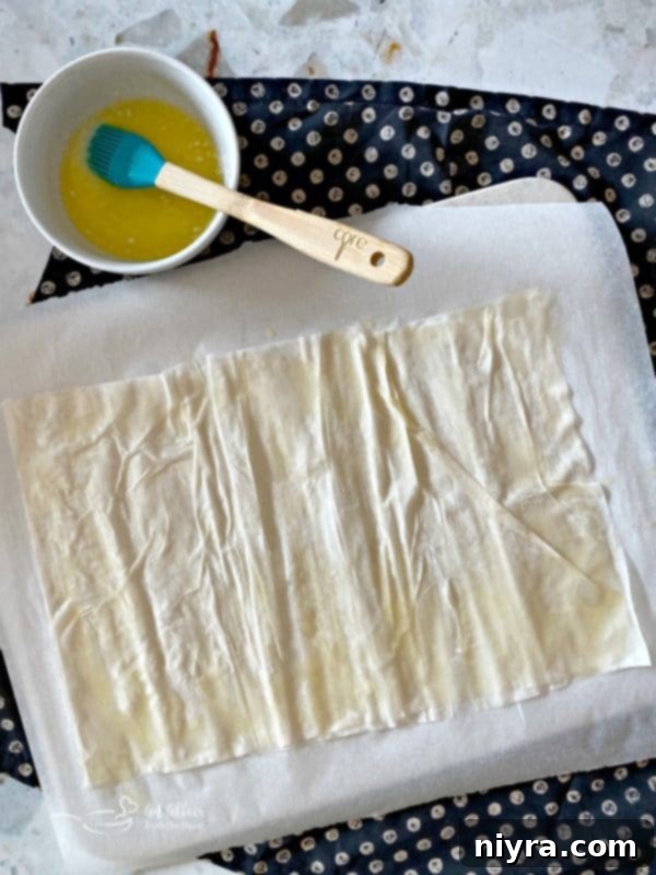 Layering and buttering phyllo dough sheets