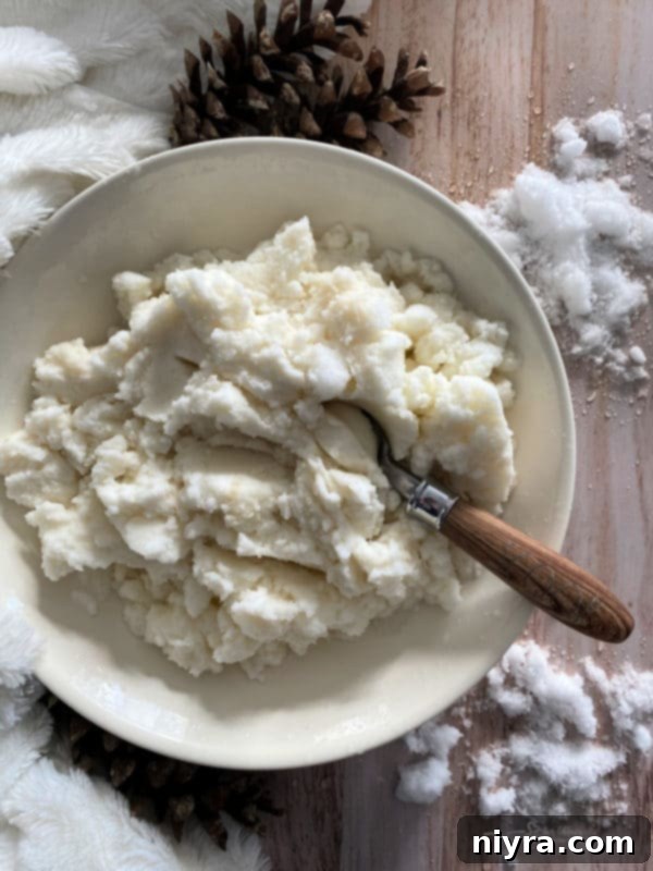 A large bowl filled with fluffy white snow, ready for mixing into ice cream.