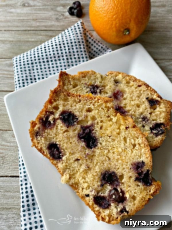 Zesty Orange Blueberry Loaf 3 Sliced Blueberry Orange Bread revealing the juicy blueberries inside.