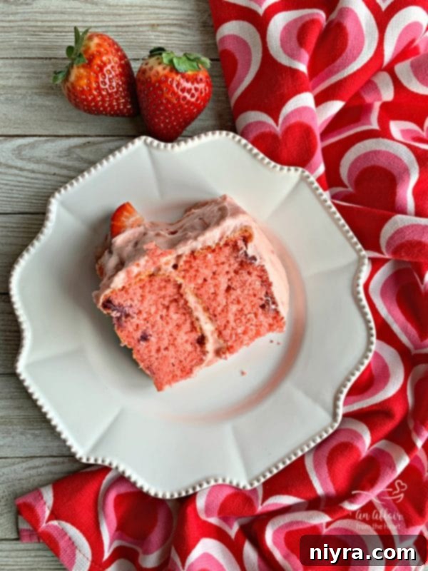 A slice of Strawberry Cake, perfect for family celebrations.