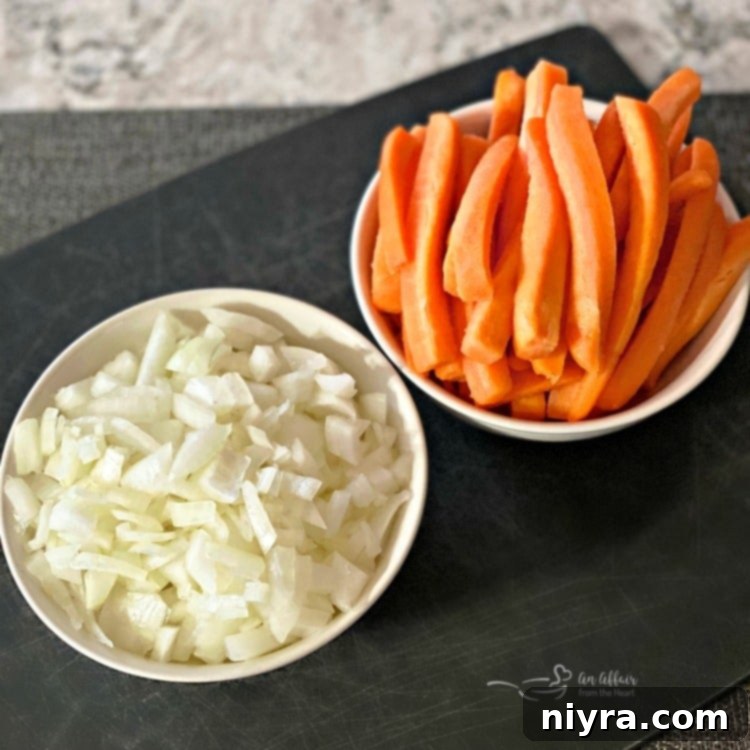 Carrots, diced tomatoes, and spices added to the sauce in a Dutch oven