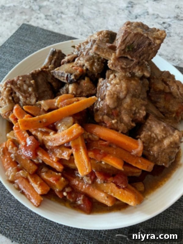 Blender blending the rich gravy in the Dutch oven after short ribs are removed