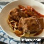 Braised Beef Short Ribs with Red Eye Gravy in a white bowl