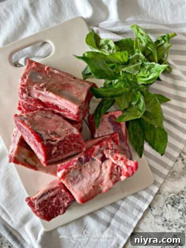 Beef Short Ribs marinating in a bowl with garlic and herbs