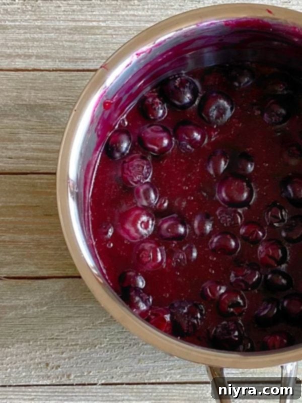 Blueberry filling cooking in a saucepan