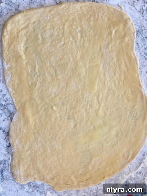 Dough being rolled out on a counter