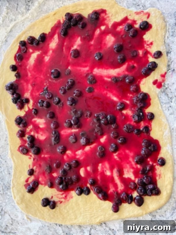 Dough spread with filling, ready to be rolled