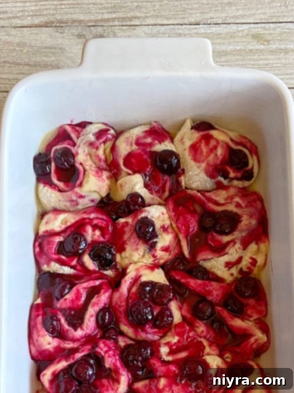 Sliced sweet rolls placed in a baking pan