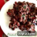 Overhead view of delicious homemade Peanut Clusters on a white plate, ready for holiday enjoyment.