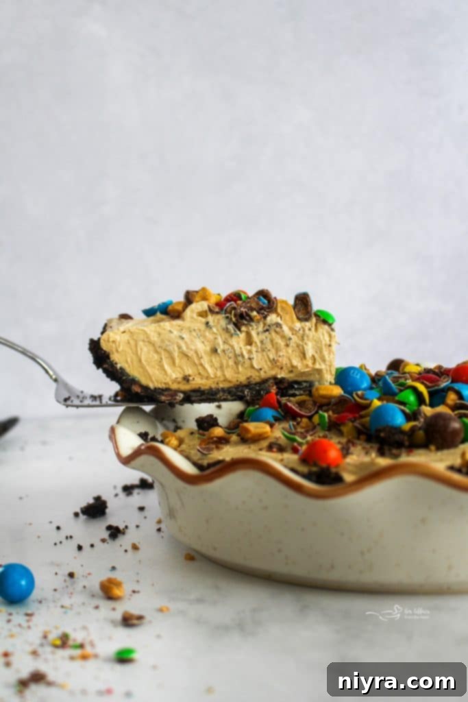 Ultimate Peanut M and M Peanut Butter Pie 7 Various ingredients for the pie laid out on a table, including Oreos, M&M's, and peanut butter