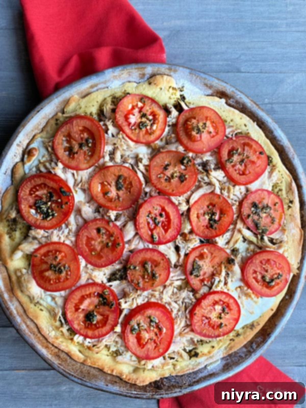 Flavorful Chicken Pesto Pizza 3 Closeup of Simple Chicken Pesto Pizza showing fresh mozzarella and tomatoes
