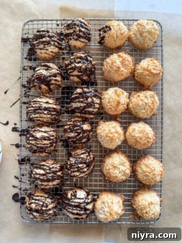 Cooling rack with coconut macaroons, some already drizzled with chocolate