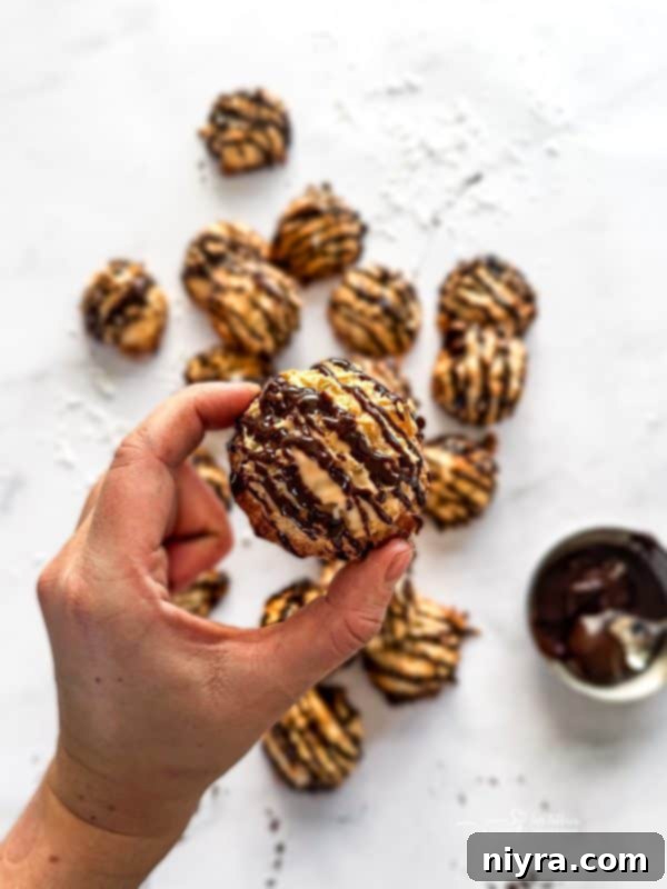 Assortment of coconut macaroons on a white platter, some plain, some with chocolate