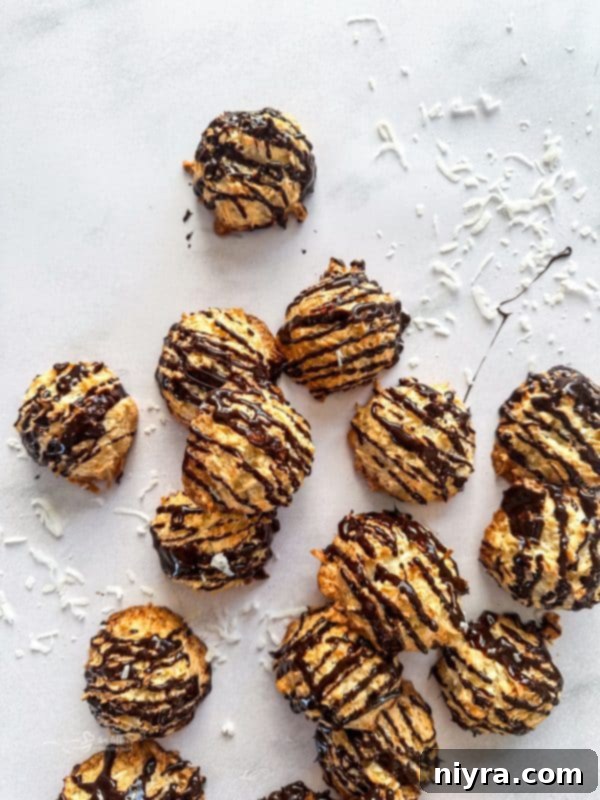 A batch of golden coconut macaroons on a cooling rack, freshly baked