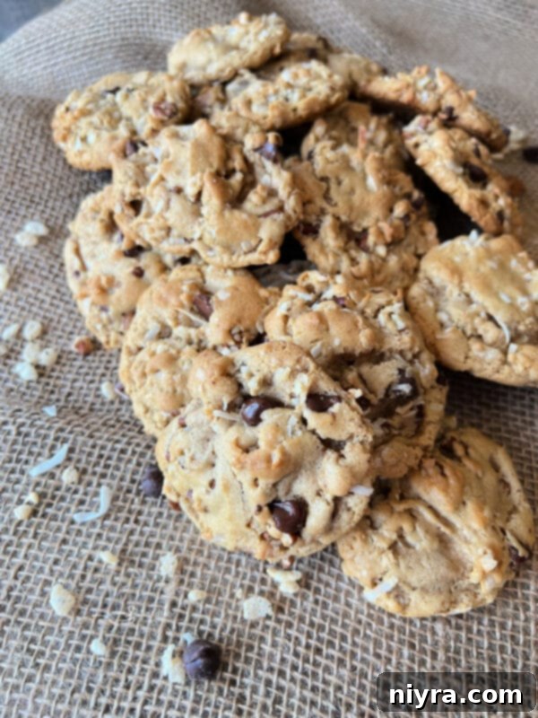 A stack of delicious Cowboy Cookies made with brown sugar, shredded coconut, and pecans
