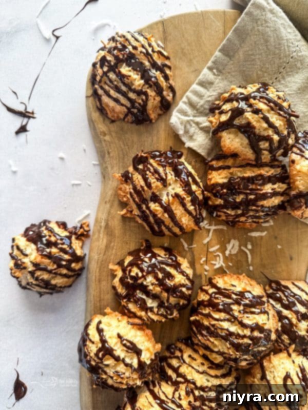 Close-up of golden coconut macaroons cooling on a wire rack, ready for chocolate