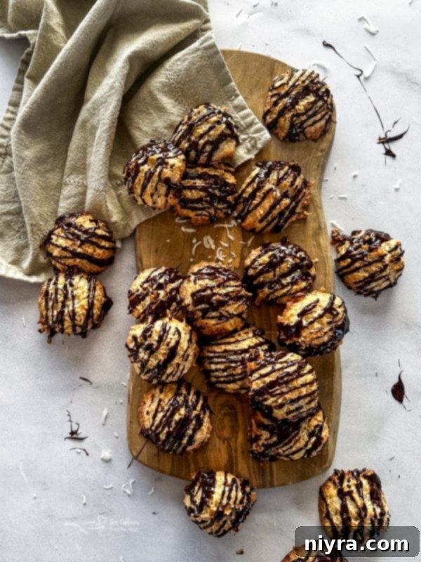 A stack of perfectly golden coconut macaroons on a baking sheet