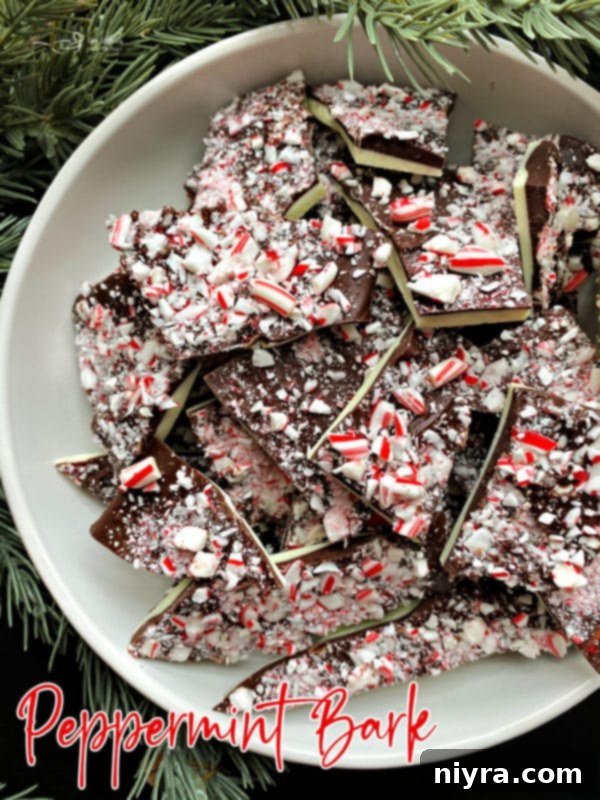 Large, artistic close-up of white and dark chocolate peppermint bark, emphasizing its festive appeal and inviting texture.