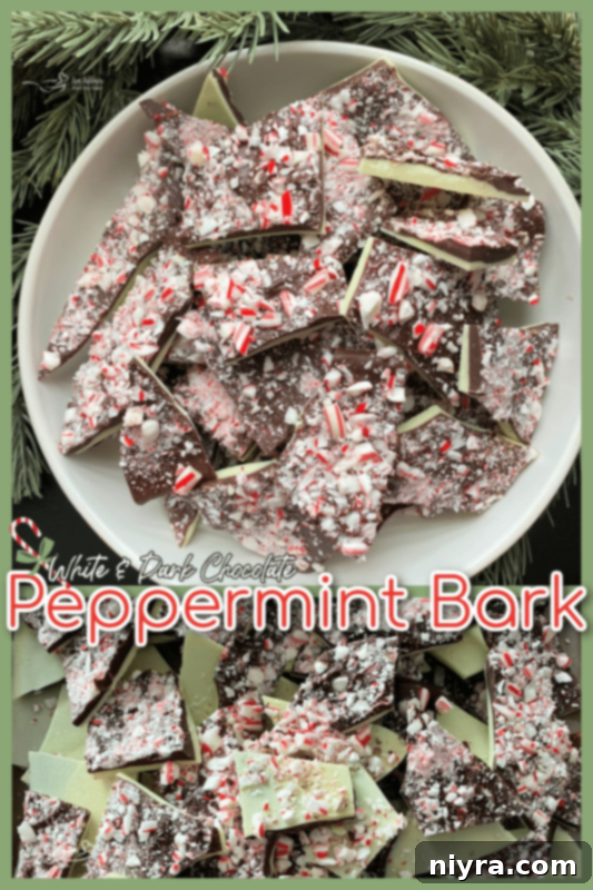Beautifully arranged pieces of white and dark chocolate peppermint bark on a platter, ready for serving.