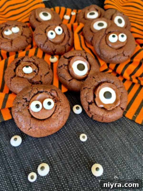 Two Halloween Chocolate Sugar Cookies with one large candy eyeball each
