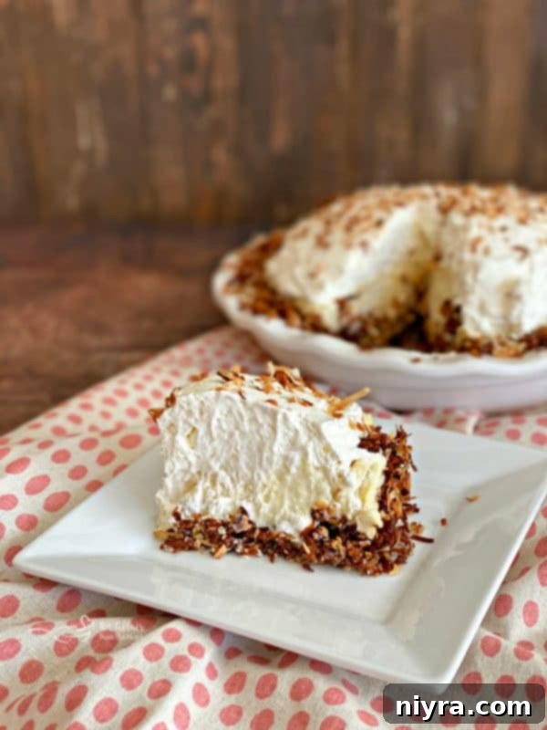 Delicious Coconut Banana Cream Pie with whipped cream and toasted coconut