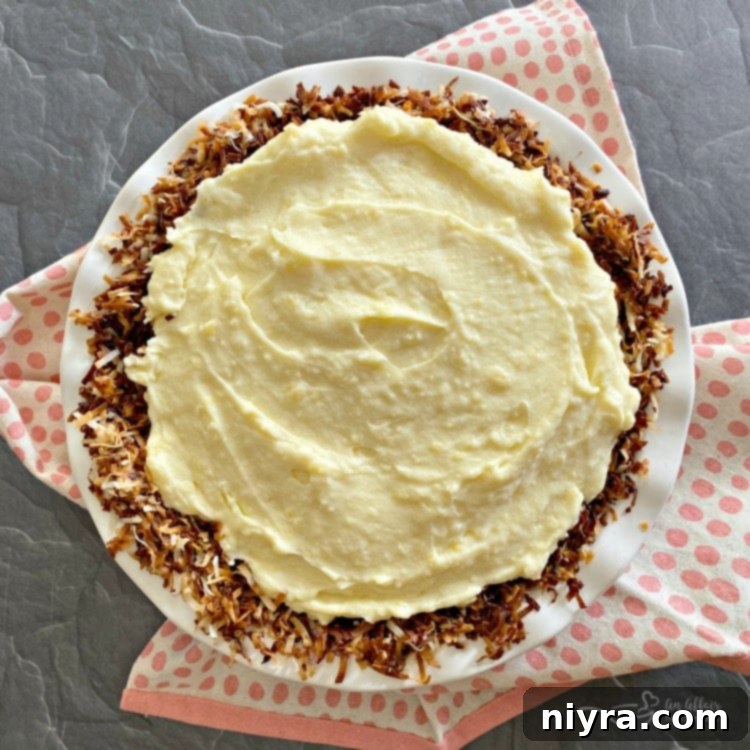 Spreading vanilla custard over bananas in a pie crust