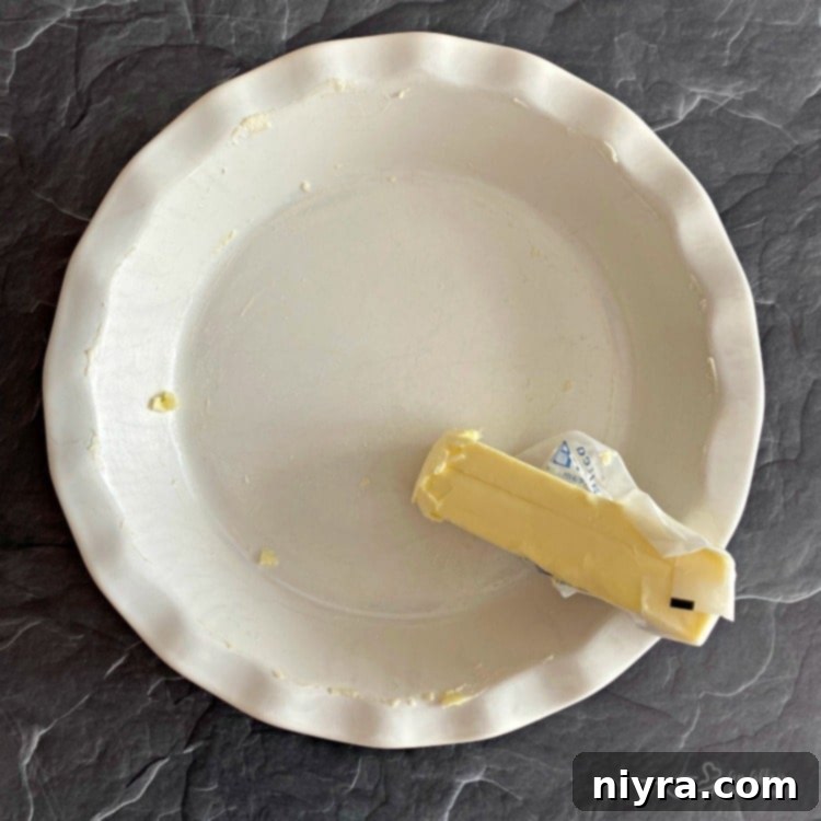 Butter a pie plate generously