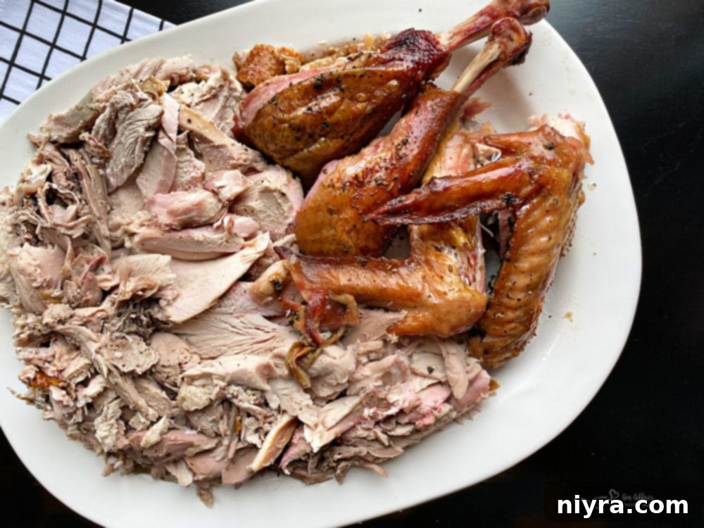 Smoked whole turkey, cooked to perfection, on a white serving platter.