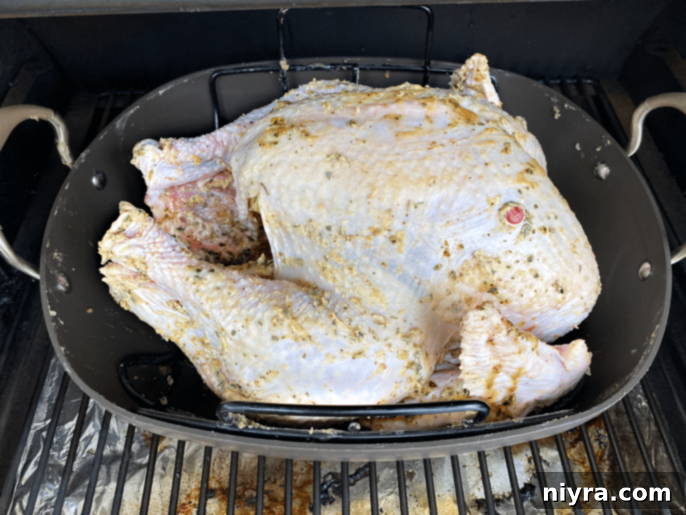 Smoked Turkey placed uncovered on a Traeger grill.
