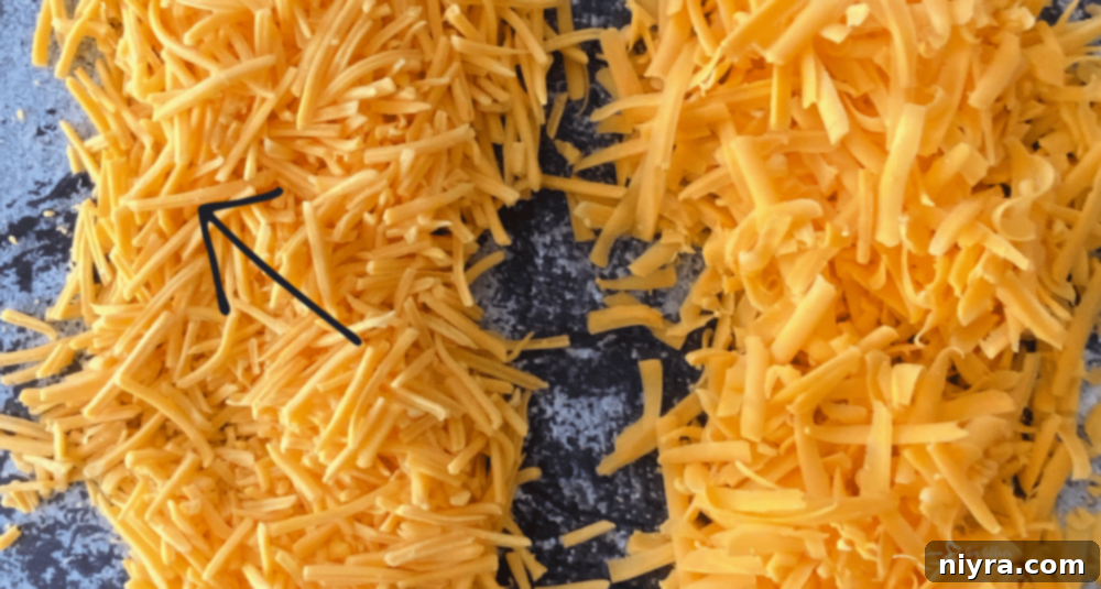 Close-up view of pre-shredded cheese showing a white coating.