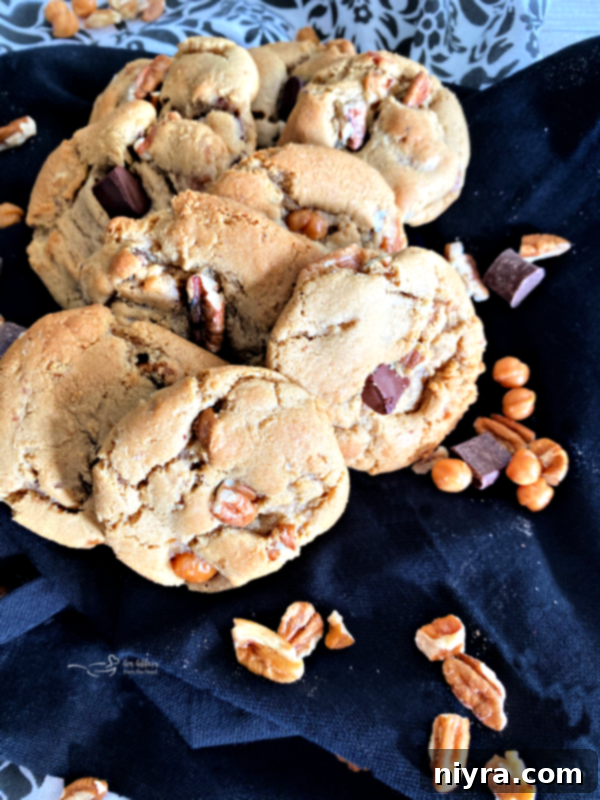 A plate of freshly baked Turtle Cookies, rich with chocolate, caramel, and pecans, ready to be enjoyed.