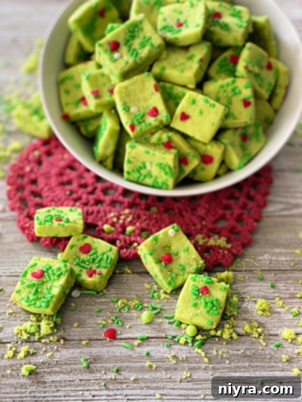 Grinch Shortbread Bites with a heart-shaped doily