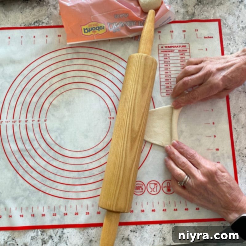 Rolling the flattened dough away from you