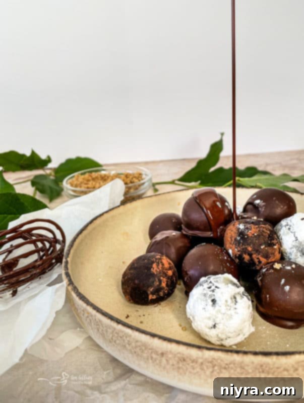 Decadent Bittersweet Chocolate Bourbon Balls 12 A close-up of a single Bittersweet Chocolate Bourbon Ball with a rich chocolate coating, highlighting its inviting texture.