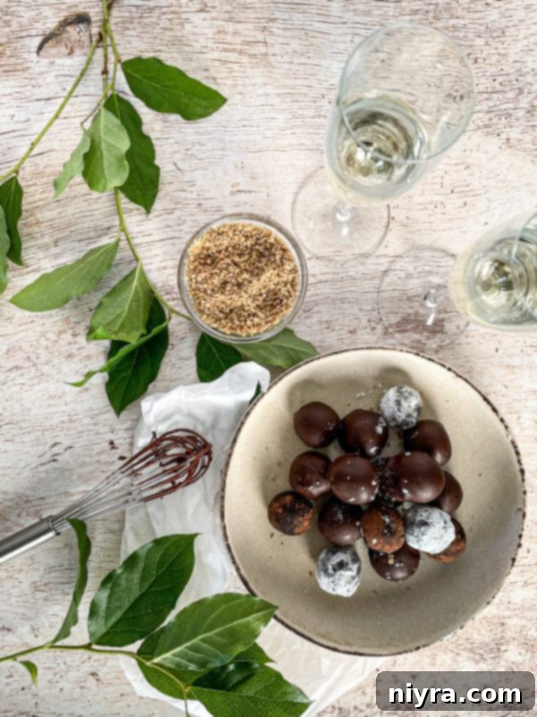 Decadent Bittersweet Chocolate Bourbon Balls 13 A beautifully composed image of Chocolate Bourbon Balls, some with a chocolate glaze, others with powdered sugar, creating a varied texture.