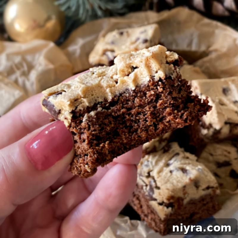 Cookie Dough Brownie Dream 3 Overhead view of chocolate chip cookie dough brownies with a bite taken out of one