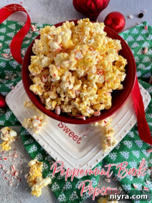 Peppermint Bark Popcorn served in a festive red bowl.