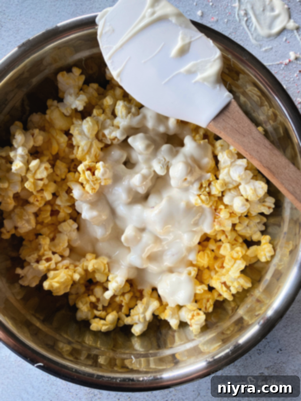 Ingredients for peppermint bark popcorn laid out: almond bark, oil, candy canes, popcorn.