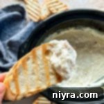 Close up of Slow cooker crab dip on a piece of toast