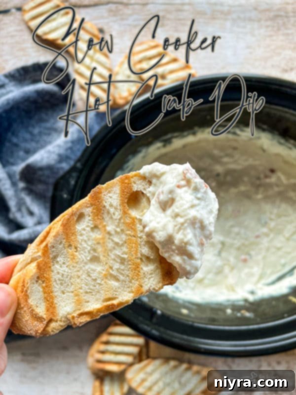 A beautifully presented Slow Cooker Crab Dip in a crockpot, ready to serve.