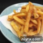 Perfectly Crispy Homemade French Fries 18 homemade french fries on a plate