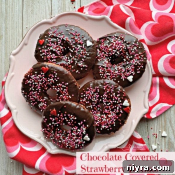 Chocolate Covered Strawberry Baked Donuts on a pink plate
