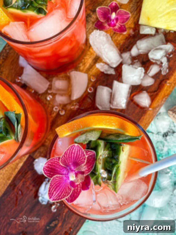 A refreshing Tropical Sparkling Cocktail with pineapple and orange slices, ready to be enjoyed