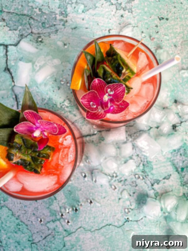 Pouring the shaken cocktail mixture into an ice-filled glass