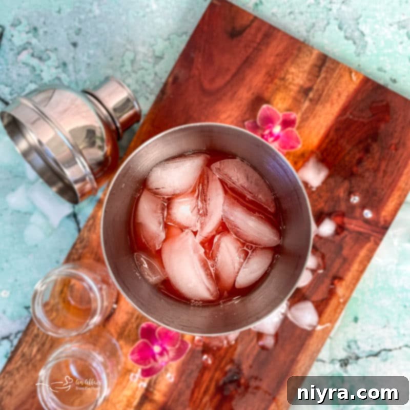 A cocktail shaker filled with ingredients and ice, ready to be mixed