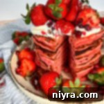 Dreamy Strawberry Pancakes 18 Close up of stacked Strawberry pancakes loaded with strawberries on top