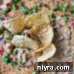 Ultimate Sausage Cheese Dip 12 Close up of sausage cheese dip with chips in it